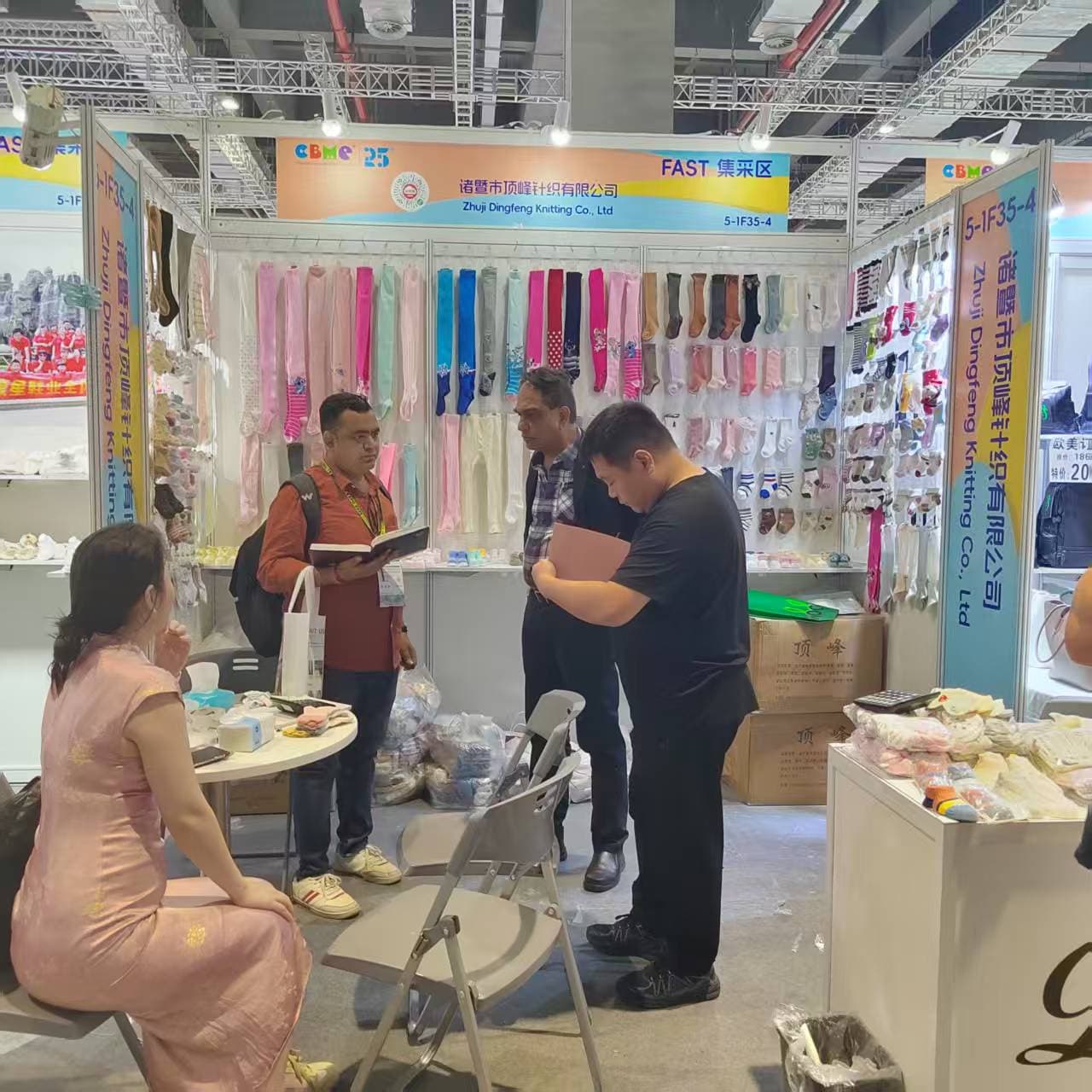 CustomizeSocks team speaking with customers at a trade show
