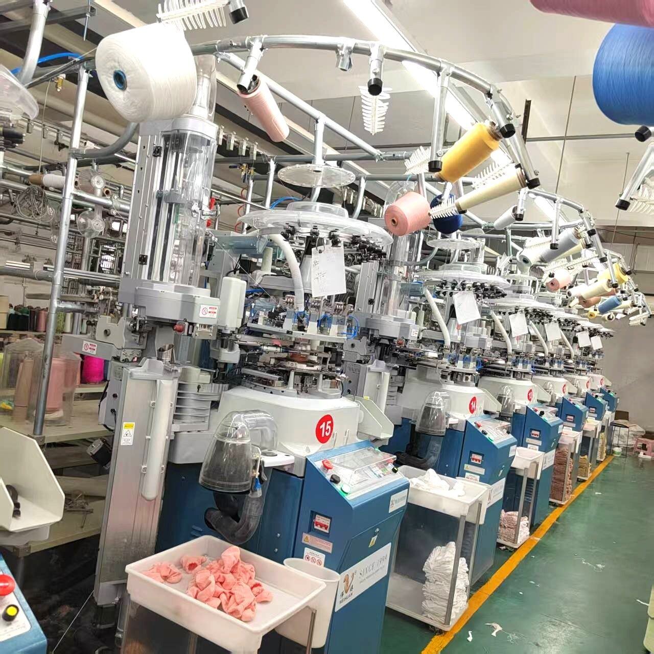 Industrial sock knitting machine in operation